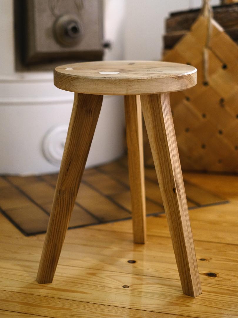 IINO jakkara kuvattuna takan edessa, käsintehty massiivipuusta, valmistettu Raumalla